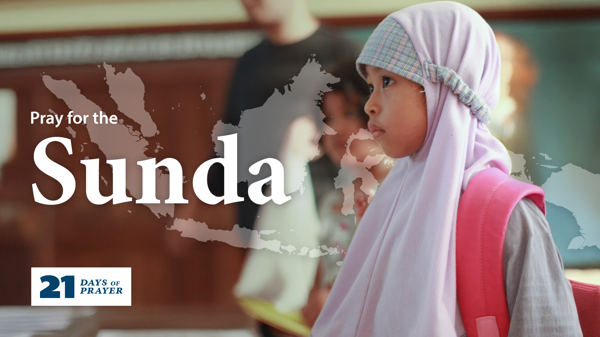 A close up photo of a Sunda girl learning in school while wearing a pink backpack.